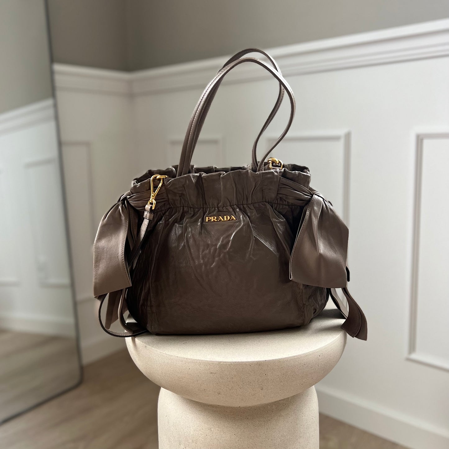 Prada handbag / crossbody in leather with bows